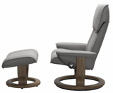 Gray Stressless recliner chair with matching ottoman on a white background