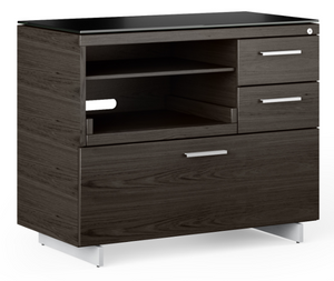 The Sequel 6117 multifunction cabinet is designed to maximize compact office spaces and is designed with convenient features such as a pullout shelf for easy access to a printer, scanner, or all-in-one, an adjustable shelf for paper storage, two storage drawers and a lateral file drawer. This modern file cabinet is topped with highly durable and unbelievably soft black satin-etched tempered glass that resists dings, scratches, and fingerprints.